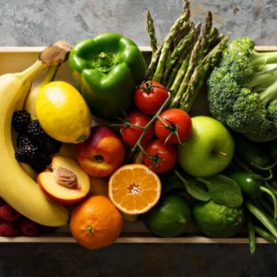 Fresh and colorful vegetables and fruits in a wooden crate