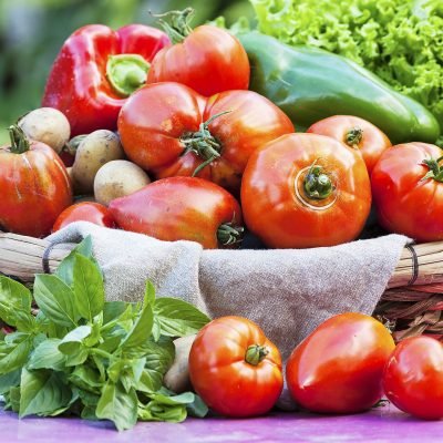 Vegetables in a basket on table under sunlight